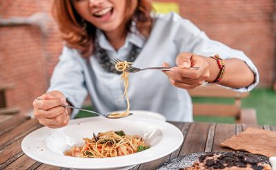 asian-women-eating-delicious-focus-on-hand-