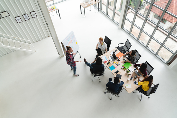 top-view-of-diverse-people-of-creative-team-group-using-smartphone-mobile-phone-tablet-and-computer-laptop-while-meeting-overhead-view-of-asian-young-creative-start-up-meeting-with-wide-angle-view-