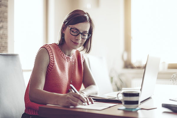 
Uma jovem mulher a estudar em casa utilizando a técnica Pomodoro. 