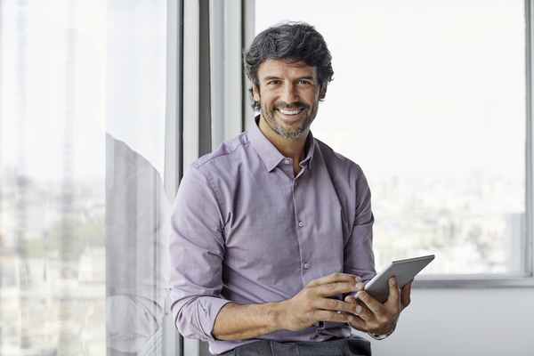 smiling-male-executive-using-digital-tablet