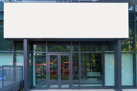 White billboard in front of modern office entrance